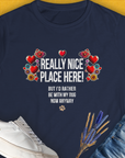 The womens navy T-shirt features a floral heart with the quote Really Nice Place Here! But Id rather be with my dog now anyway. Perfect for any dog lover. Designed by Dog Gang.