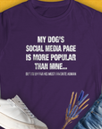 Purple womens t-shirt with the saying My Dogs Social Media Page Is More Popular Than Mine. Its a funny shirt for any dog lover. Designed by Dog Gang.