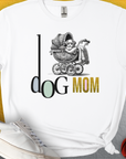 The Dog Mom Series, Volume 5 Unisex T-Shirt features Dog Mom with a puppy in a vintage stroller design. Perfect for the stylish and cozy dog owner. Designed by Dog Gang.
