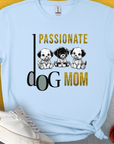 This Dog Mom Series, Volume 6, blue unisex T-shirt features the saying Passionate Dog Mom alongside three cute puppy illustrations. Designed by Dog Gang.