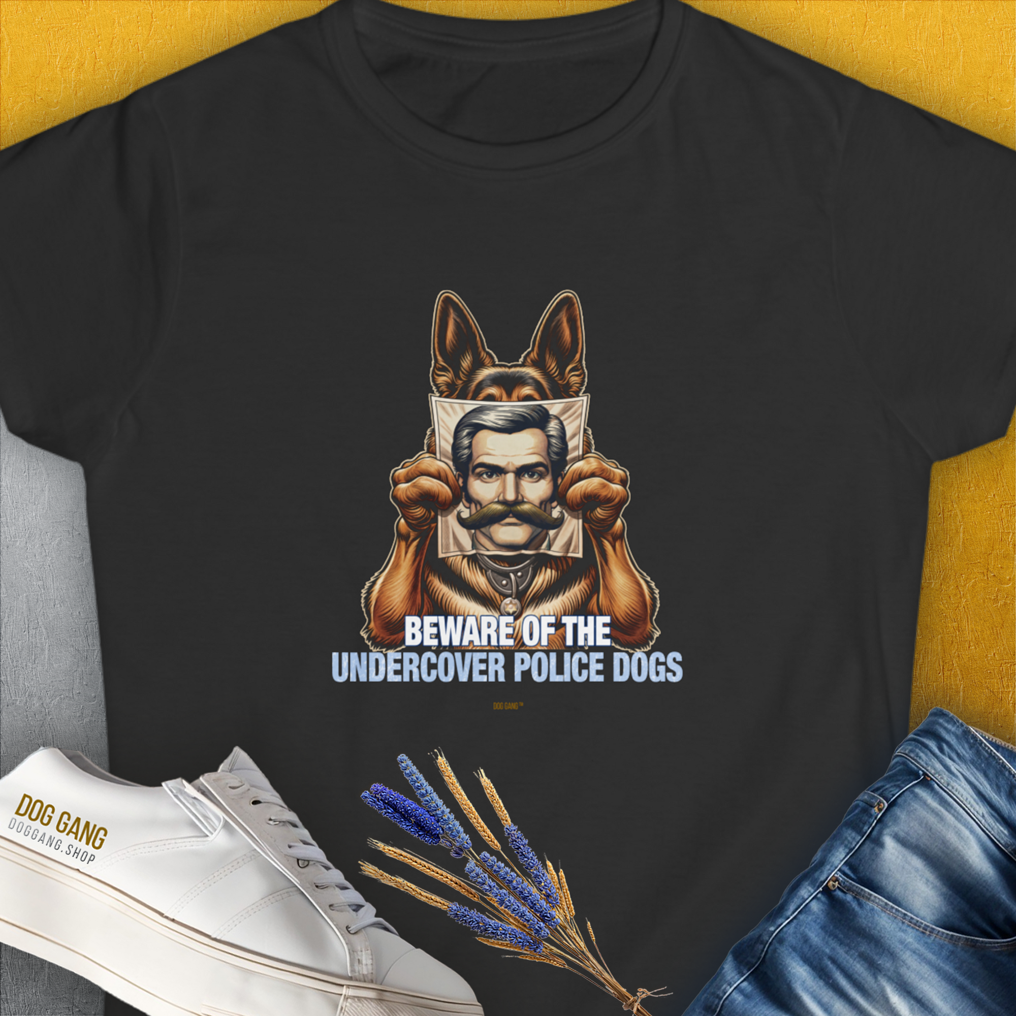 The black t-shirt showcases a funny dog design with the text Beware Of The Undercover Police Dogs, Volume 1. Perfect for any dog lover. Designed by Dog Gang.