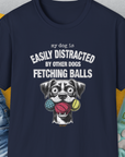Navy tee with My Dog Is Easily Distracted By - Volume 4: Other Dogs Fetching Balls text and playful dog illustration with balls for the dog lover. Designed by Dog Gang.