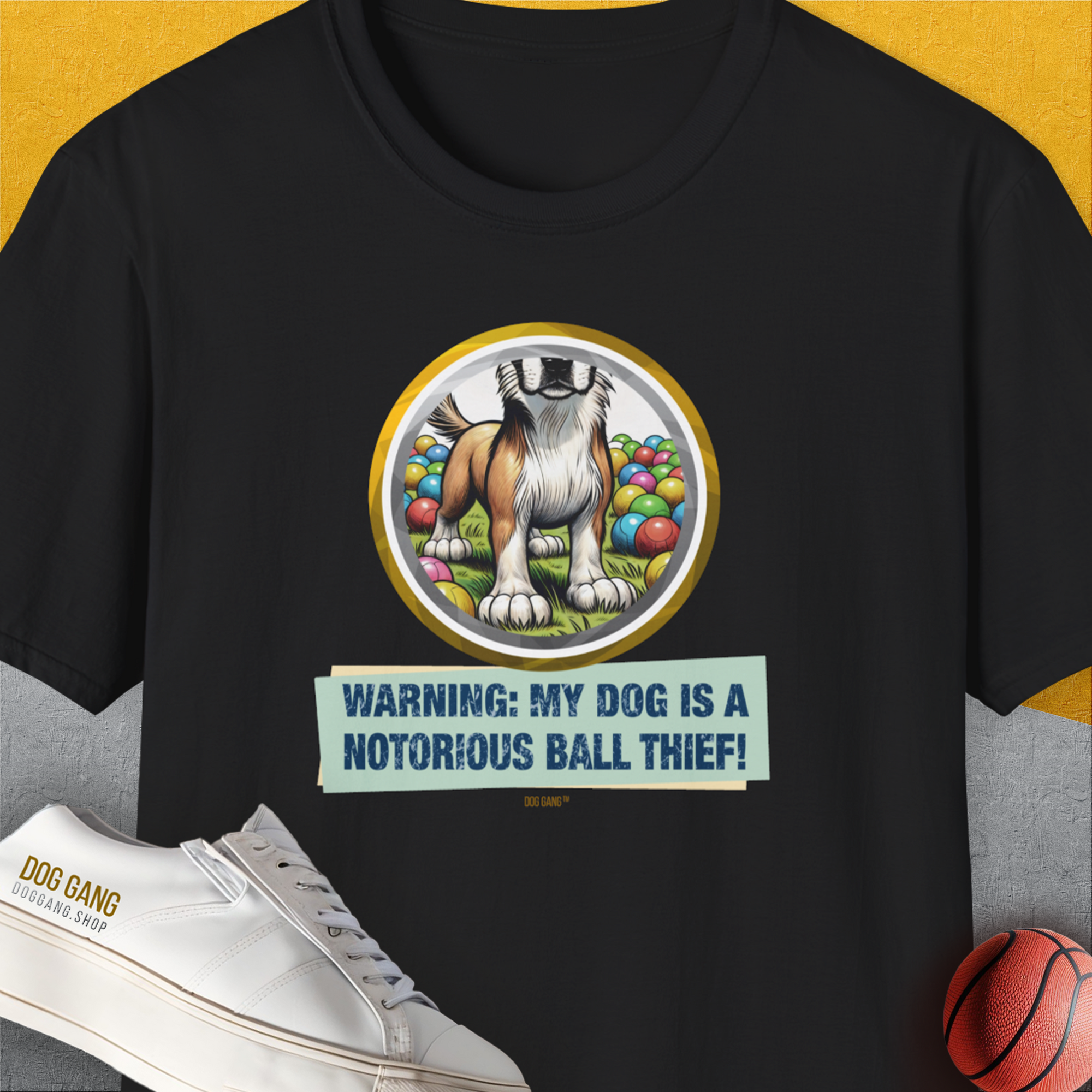 Funny dog shirt: Warning: My Dog Is A Notorious Ball Thief, Volume 2 with a playful illustration of a mischievous dog and colorful balls. Designed by Dog Gang.