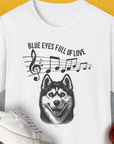 The Blue Eyes Full Of Love, Volume 1 (Husky) shirt showcases a playful husky with music notes and a basketball—perfect for any dog lover. Designed by Dog Gang.
