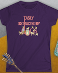 The Easily Distracted By Dogs Series, Volume 2, womens t-shirt is a purple semi-fitted design with Easily Distracted by Dogs in pink lettering featuring playful dog illustrations. Designed by Dog Gang.