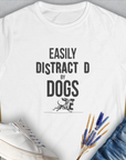 Easily Distracted By Dogs with a cute dog design in playful fonts. Perfect for any dog lover. Designed by Dog Gang.