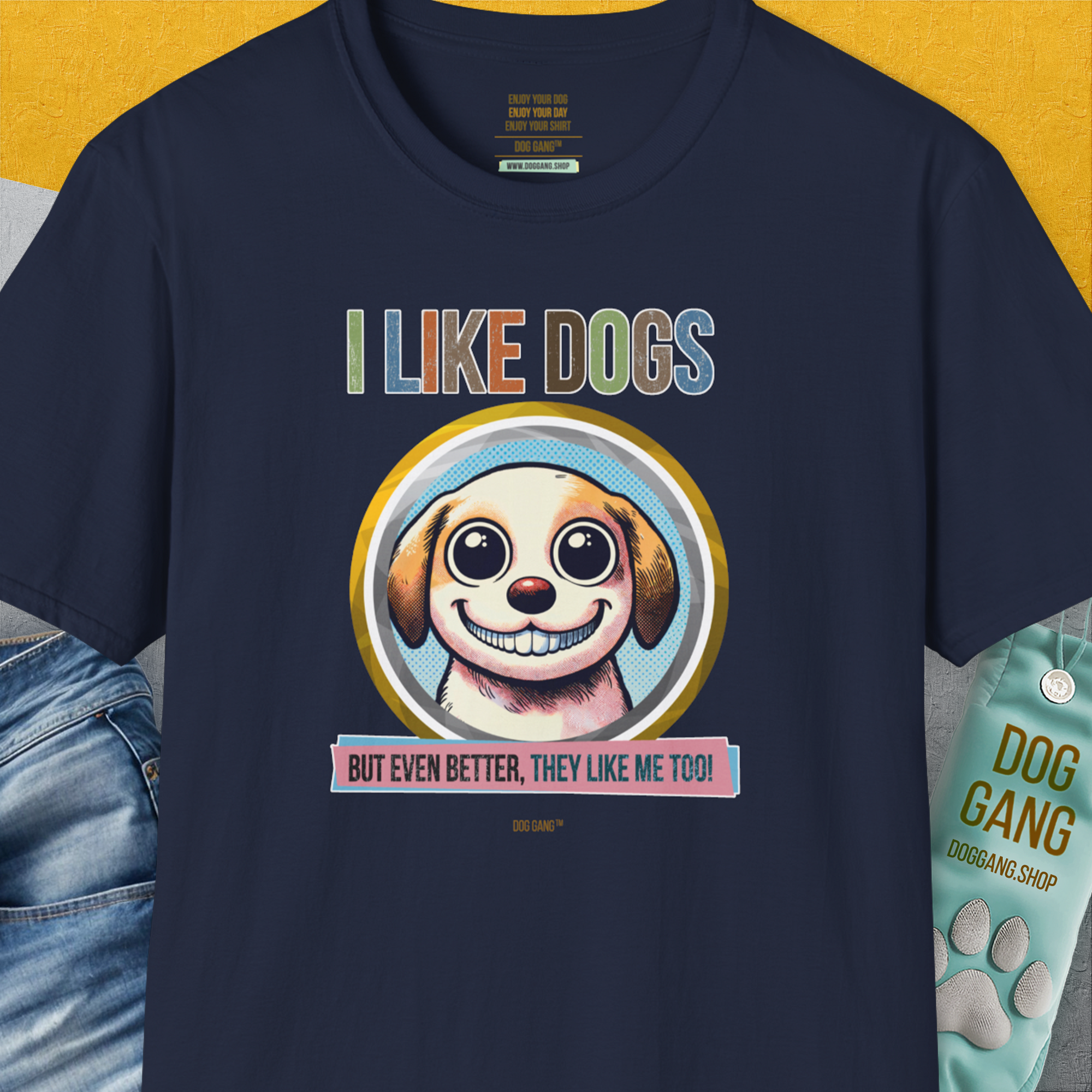 The navy I Like Dogs And They Like Me Too, Volume 1 unisex tee features a smiling dog illustration with the phrases I LIKE DOGS and But even better, they like me too! in yellow. Designed by Dog Gang.
