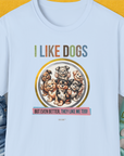 The light blue unisex T-shirt showcases cartoon dogs with the quote, I LIKE DOGS, BUT EVEN BETTER, THEY LIKE ME TOO! Perfect for any dog person. Designed by Dog Gang.