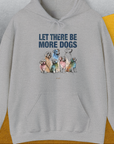 The Let There Be More Dogs Unisex Hoodie features colorful dog illustrations and the text LET THERE BE MORE DOGS, making it a perfect dog lover gift. Designed by Dog Gang.