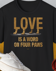The Love Is A Word On Four Paws, Volume 2, Unisex T-Shirt features an endearing quote styled with adorable dog paws integrated into the lettering. Perfect for any dog lover. Designed by Dog Gang.
