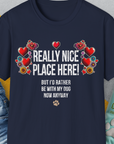 This navy unisex t-shirt features a floral and heart design with the funny quote: Really nice place here! But Id rather be with my dog now. Designed by Dog Gang.