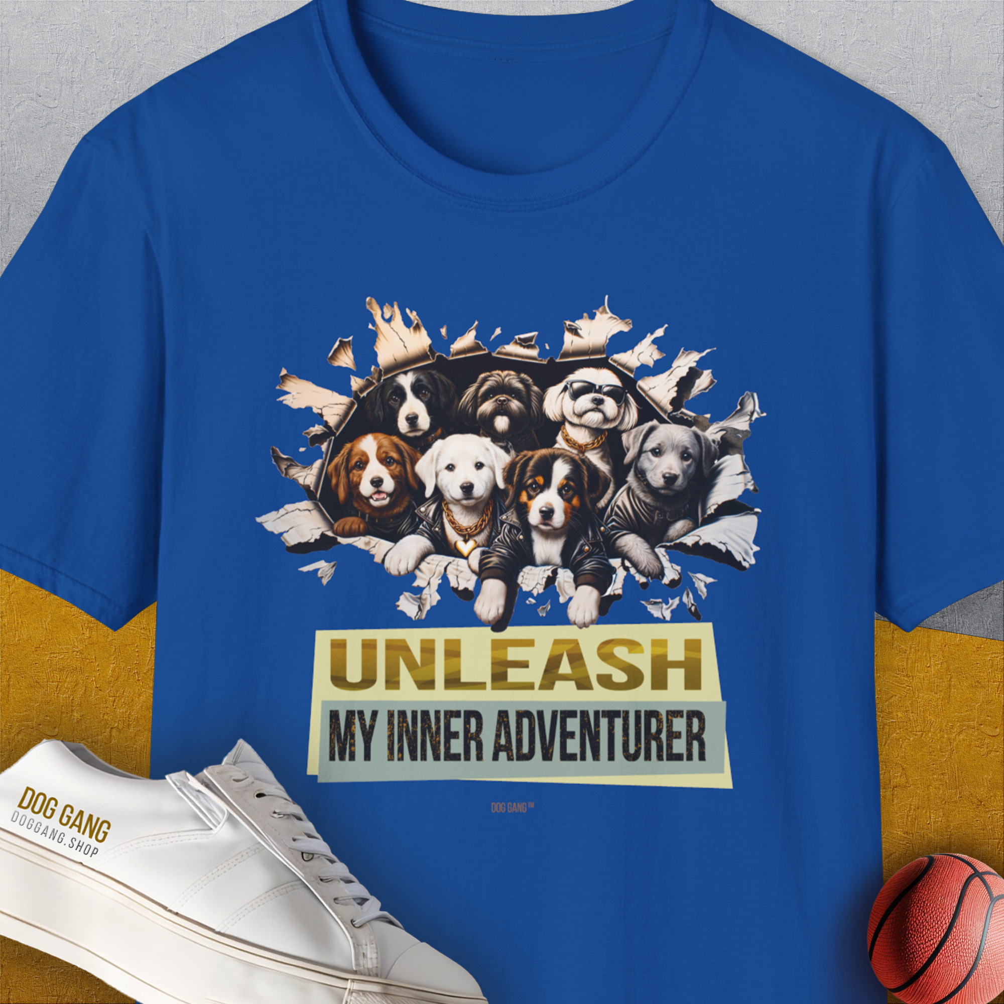 Royal-colored Unleash-Series T-shirt featuring playful puppies breaking through paper with the text UNLEASH MY INNER ADVENTURER, and a small ball. Designed by Dog Gang.