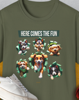 Military green tee with cartoon dogs and the text Here Comes The Fun. A funny dog shirt for playful spirits. Designed by Dog Gang.