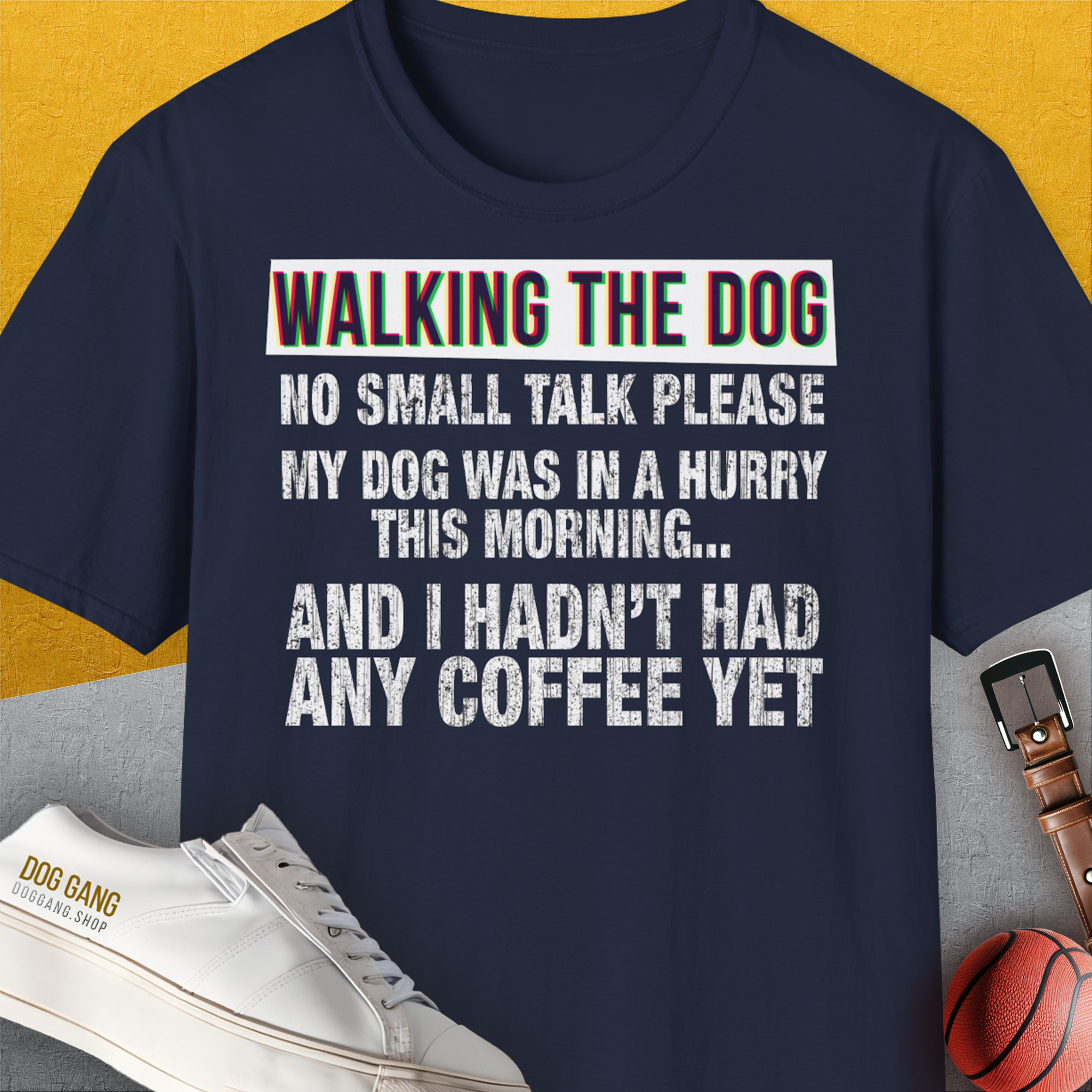 Navy tee features funny text: Avoid Small Talk Until After Coffee in bold, artsy letters. Designed by Dog Gang.