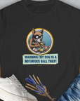 The Warning: My Dog Is A Notorious Ball Thief, Volume 1 black T-shirt showcases a cute dog design with a masked cartoon dog surrounded by balls. Ideal for any dog lover. Designed by Dog Gang.