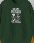 Forest green hoodie with a cute dog design: person and dog in the rain with Who Cares About The Weather When Youre In Good Company text. Perfect for any dog lover. Designed by Dog Gang.
