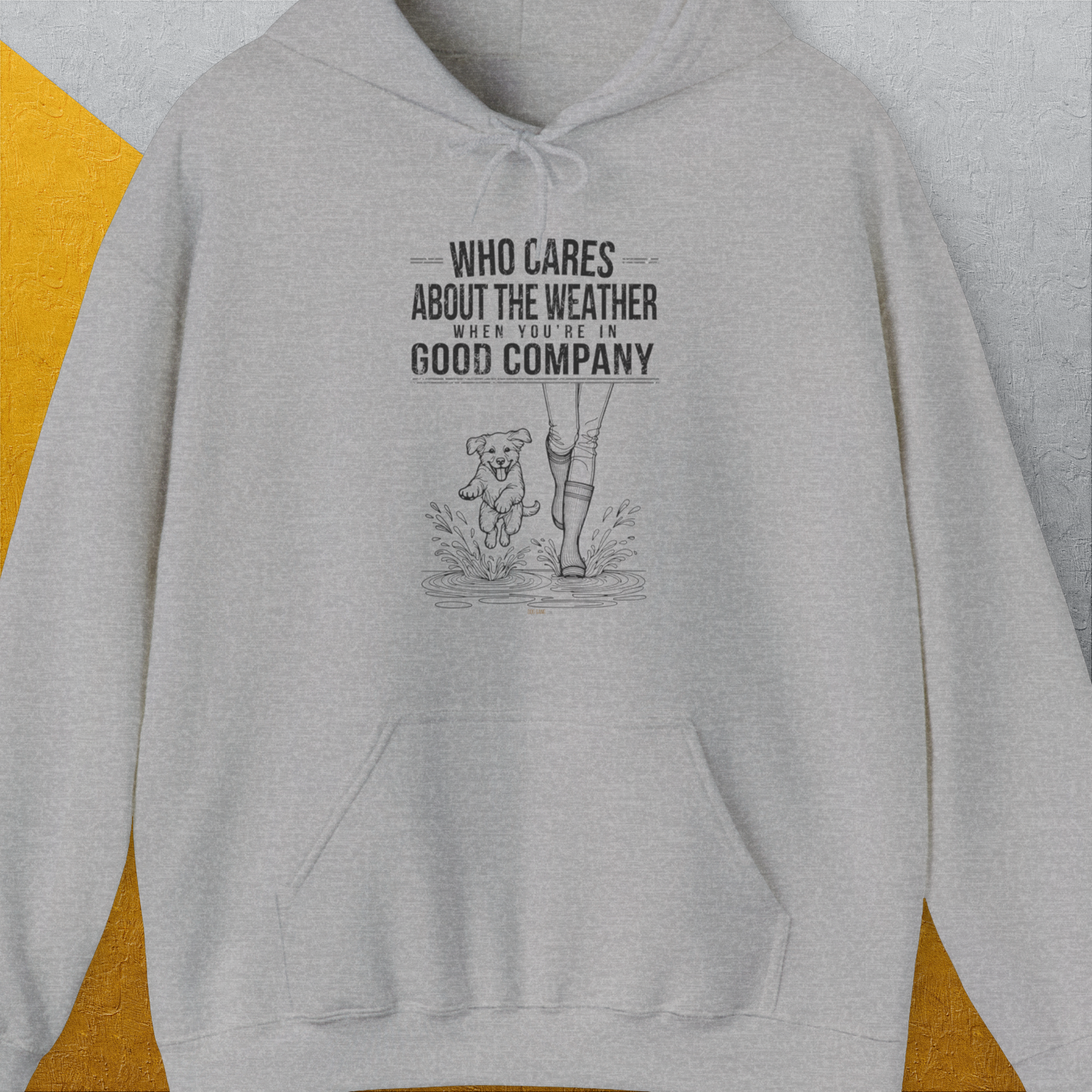 The unisex hoodie features a cute dog design with a mix of human and dog legs. The phrase reads, Who cares about the weather when youre in good company. Perfect for any dog lover. Designed by Dog Gang.