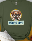The Woofs Upp? Volume 2 T-shirt is a funny dog shirt with a cartoon dog holding a bone in his mouth, saying "WOOFS UPP?" Perfect for the dog lover. Designed by Dog Gang.