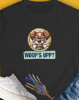 The shirt features a cute cartoon dog with the words Woofs Upp? in playful text. Funny dog design for any casual day. Designed by Dog Gang.
