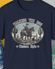 This navy tee features a funny cowboy and dog design, ideal for any dog lover. Designed by Dog Gang.