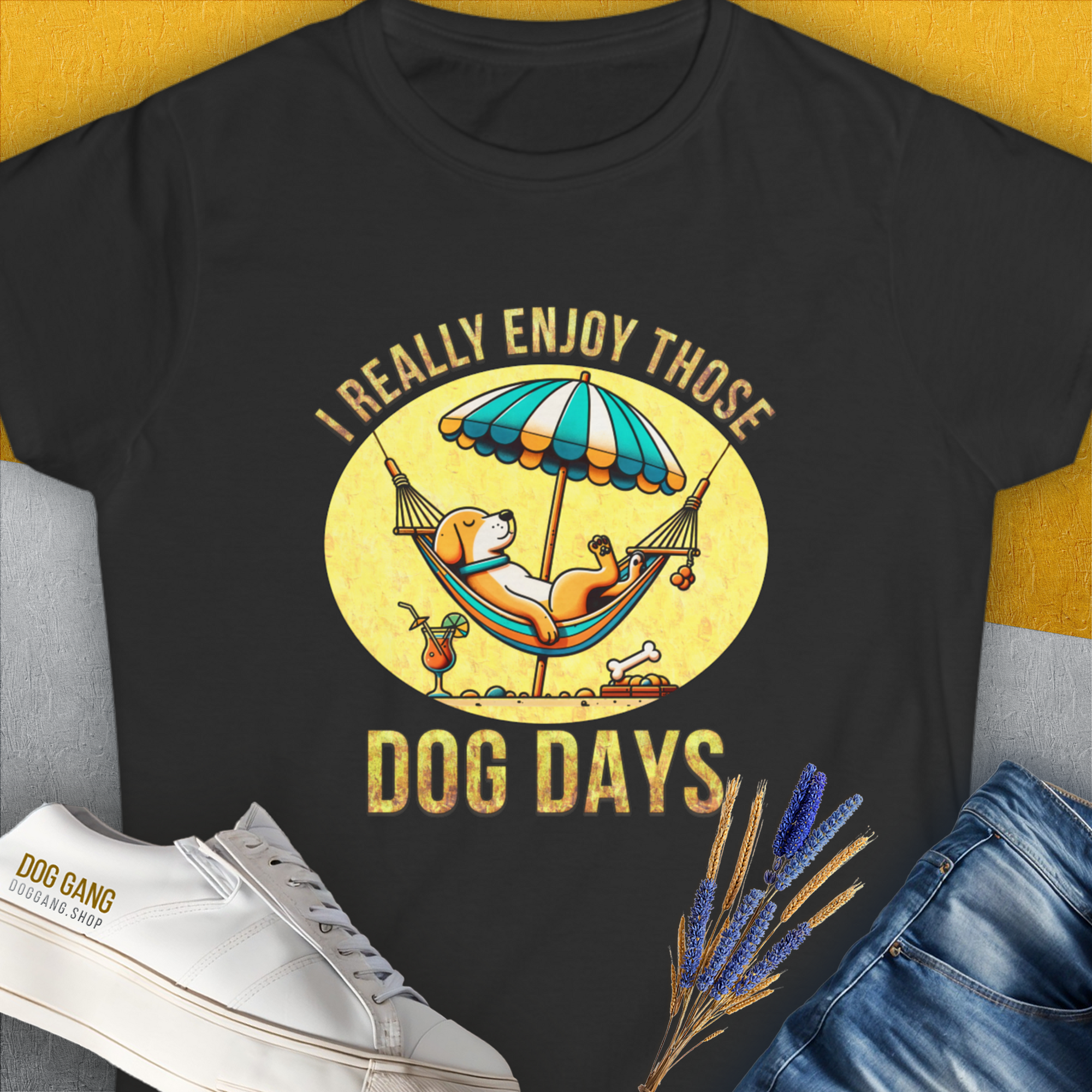 This semi-fitted black womens t-shirt features a vintage design with the quote I Really Enjoy Those Dog Days. A lounging dog under an umbrella adds a touch of whimsy for any dog lover. Designed by Dog Gang.