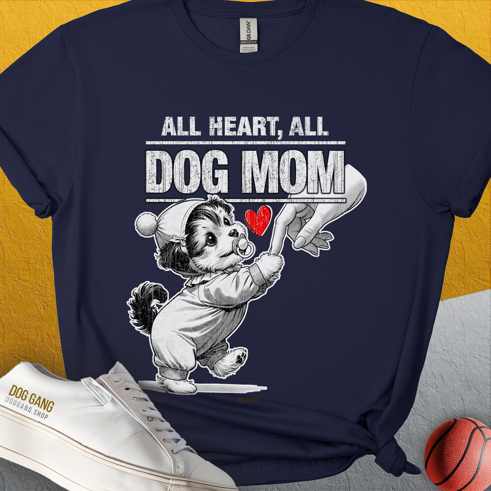 The navy t-shirt features a cartoon dog in pajamas holdin a womans hand with the saying All Heart, All Dog Mom. Designed by Dog Gang. Perfect for any dog lover or dog mom.