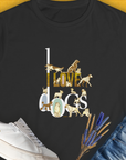 A semi-fitted I Love Dogs - Series I, Volume 1 womens T-shirt in black features the text I LOVE dogs in an ornate gold / brown -colored style, featuring illustrations of various dog breeds: a Dalmatian, a Golden Retriever, a Pug, a Poodle, Dachshund, French Bulldog, English Bulldog, Chihuahua, Husky and more. Designed in Switzerland by Dog Gang.