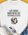 The Life Sucks When Youve Lost Your Favorite Fetch Ball, Volume 1 womens t-shirt showcases a sad dog (Labrador Retriever) illustration with a humorous quote. Designed by Dog Gang.