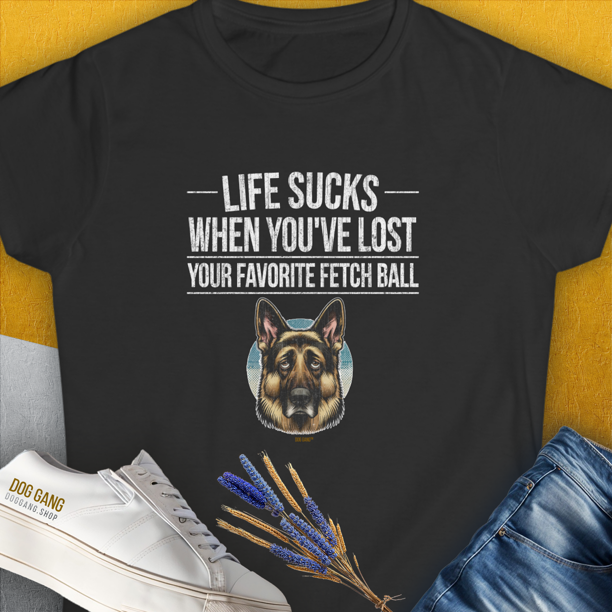 The black T-shirt showcases a German Shepherd and the humorous quote Life Sucks When Youve Lost Your Favorite Fetch Ball, Volume 4. A funny dog shirt perfect for any dog lover. Designed by Dog Gang.