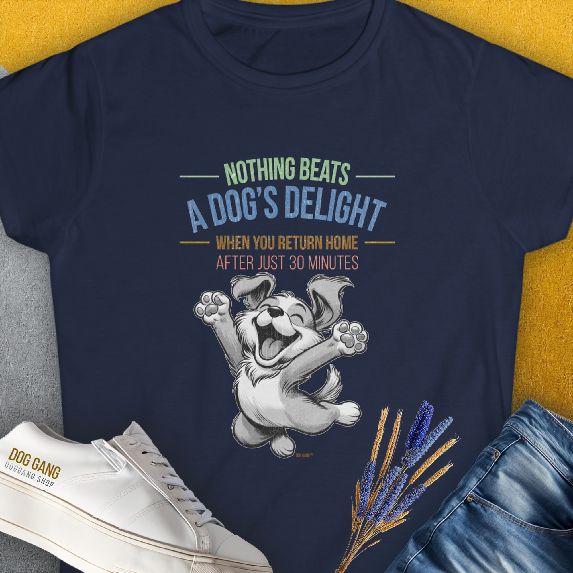 This navy womens T-shirt, designed by Dog Gang, showcases a joyful dog graphic with the playful quote: Nothing Beats A Dogs Delight When You Return Home. A must-have for any dog lover.