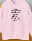 My Dog Is Easily Distracted By - Volume 2: Cats And Stuff, Unisex Hoodie-Light Pink, Design by Dog Gang