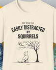 The shirt features a funny dog design with the quote "My Dog Is Easily Distracted By Squirrels", alongside an illustration of a dog and squirrels in a tree. Designed by Dog Gang.