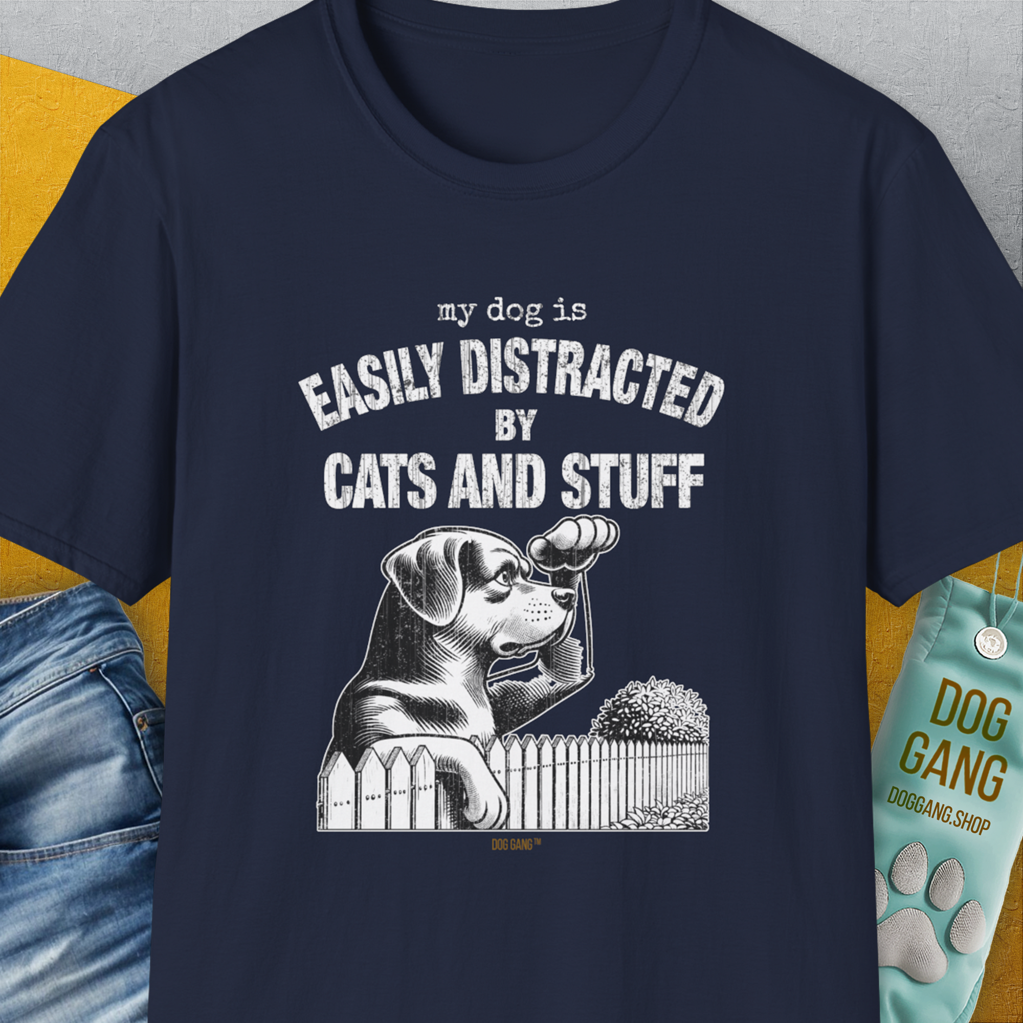 Funny dog shirt with My Dog Is Easily Distracted By - Volume 2: Cats And Stuff and a playful dog illustration peeking over a fence. Designed by Dog Gang.