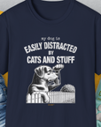 Funny dog shirt with My Dog Is Easily Distracted By - Volume 2: Cats And Stuff and a playful dog illustration peeking over a fence. Designed by Dog Gang.