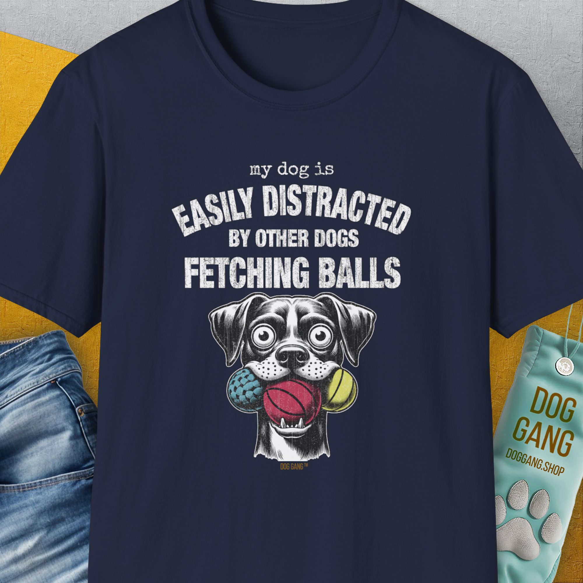 Navy tee with My Dog Is Easily Distracted By - Volume 4: Other Dogs Fetching Balls text and playful dog illustration with balls for the dog lover. Designed by Dog Gang.