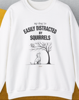 My Dog Is Easily Distracted By - Volume 1: Squirrels, Unisex Sweatshirt-White. A dog-themed Design from Dog Gang