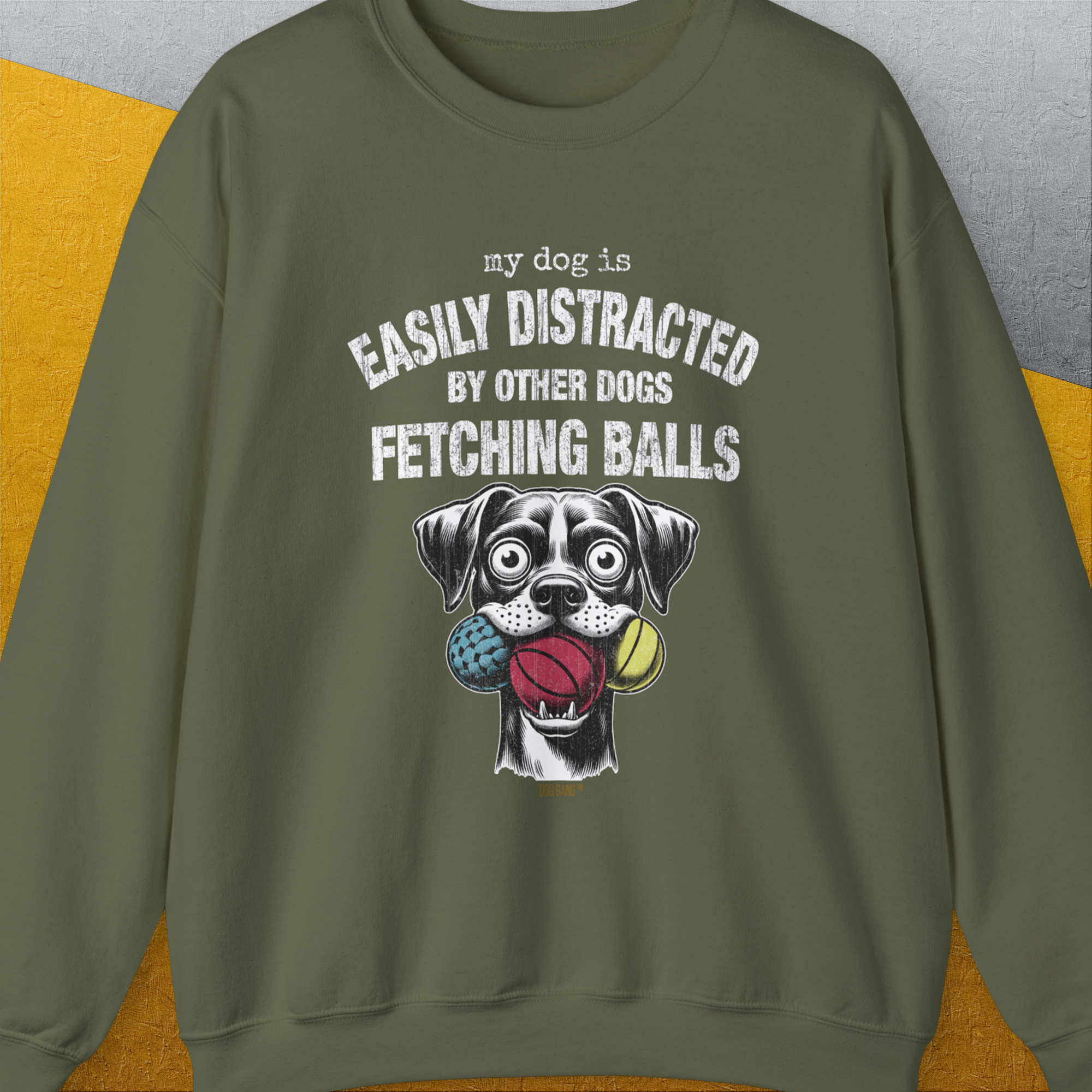 The My Dog Is Easily Distracted By Other Dogs Fetching Balls sweatshirt features a vintage design with a cartoon dog and three balls. Designed by Dog Gang.