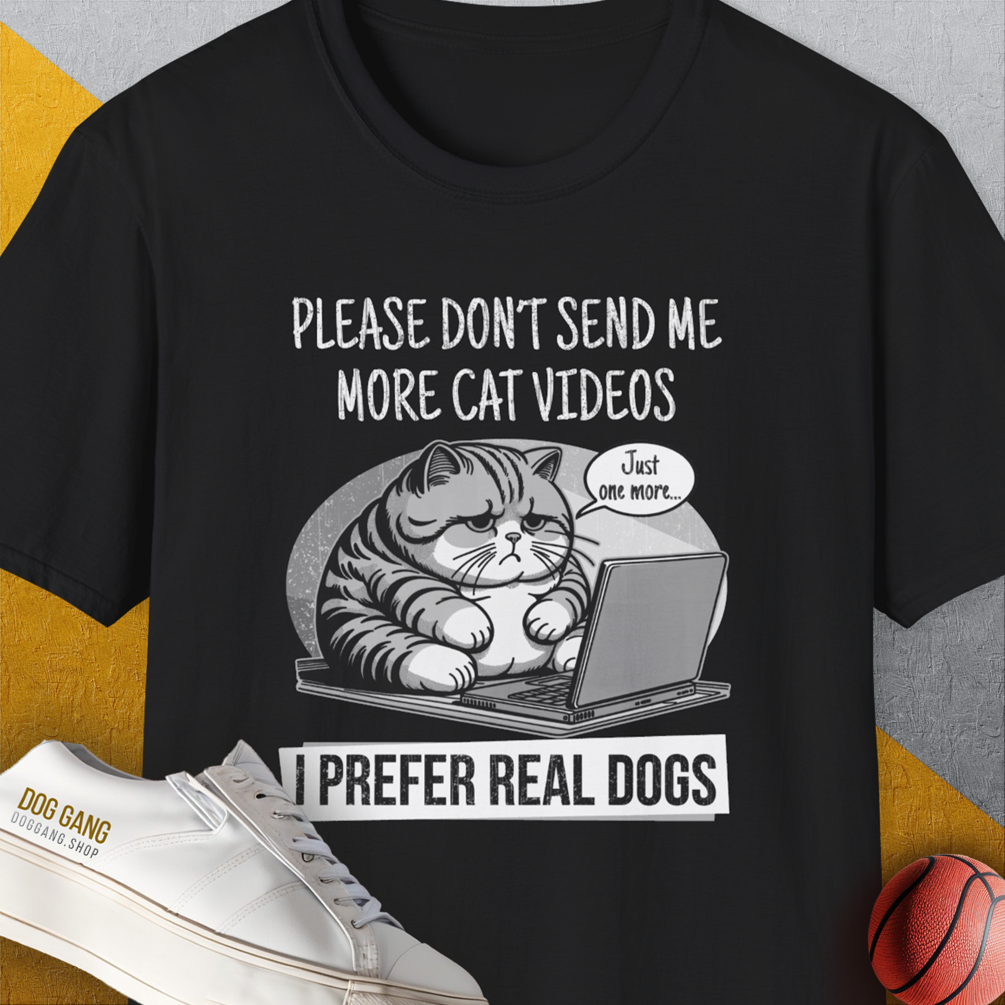 The black unisex T-shirt features a cute dog design with text saying, Please dont send me more cat videos. I prefer real dogs. Crafted from 100% cotton for ultimate comfort. Designed by Dog Gang.