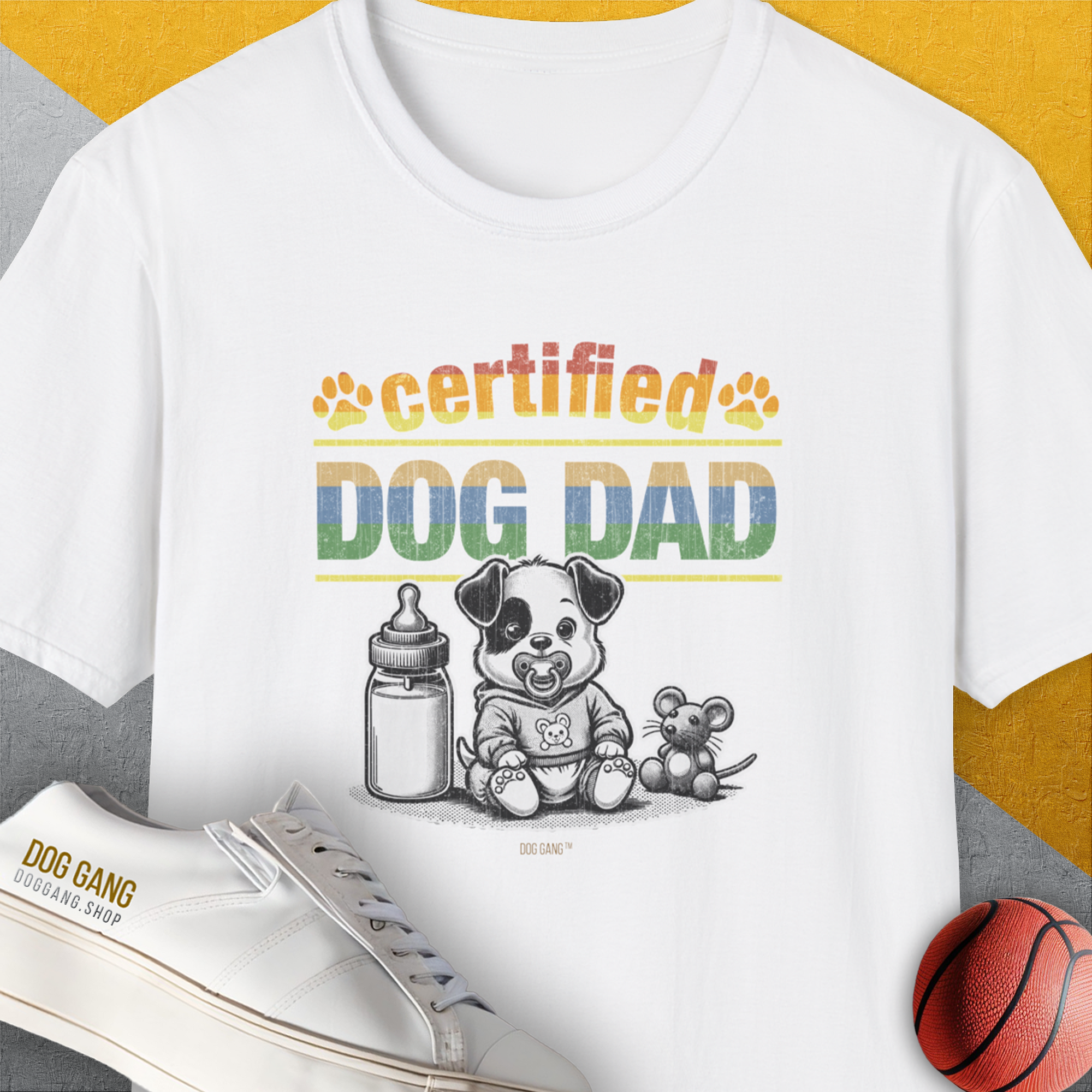 Certified “Dog Dad” text featuring a very cute cartoon puppy, a baby milk bottle and a stuffed mouse toy. Designed by Dog Gang.