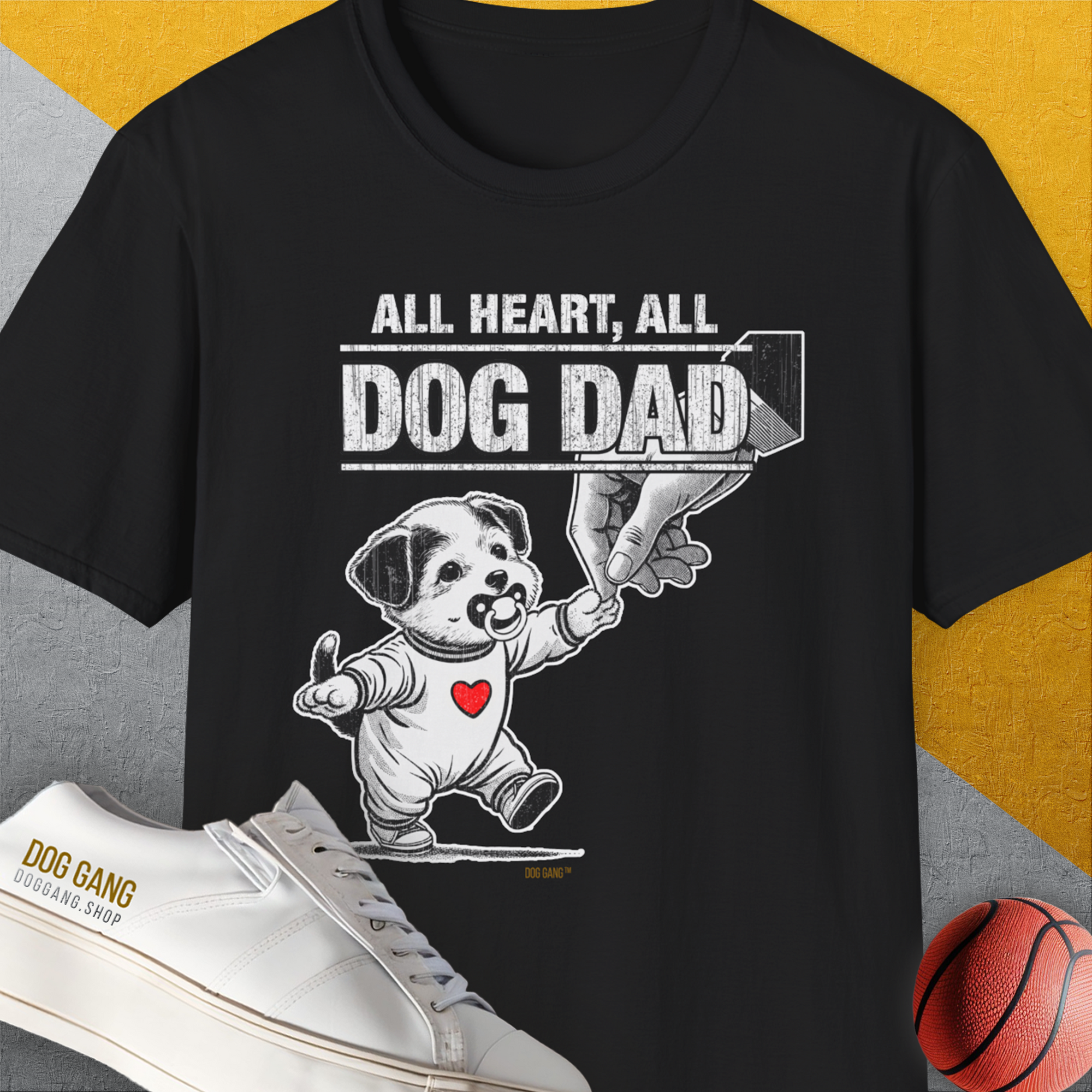 The Dog Dad Series, Volume 7 unisex black t-shirt features a cute puppy with a pscifier in mouth, holding a human hand print with the saying All Heart, all Dog Dad. Designed by Dog Gang.