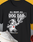 The Dog Dad Series, Volume 7 unisex black t-shirt features a cute puppy with a pscifier in mouth, holding a human hand print with the saying All Heart, all Dog Dad. Designed by Dog Gang.