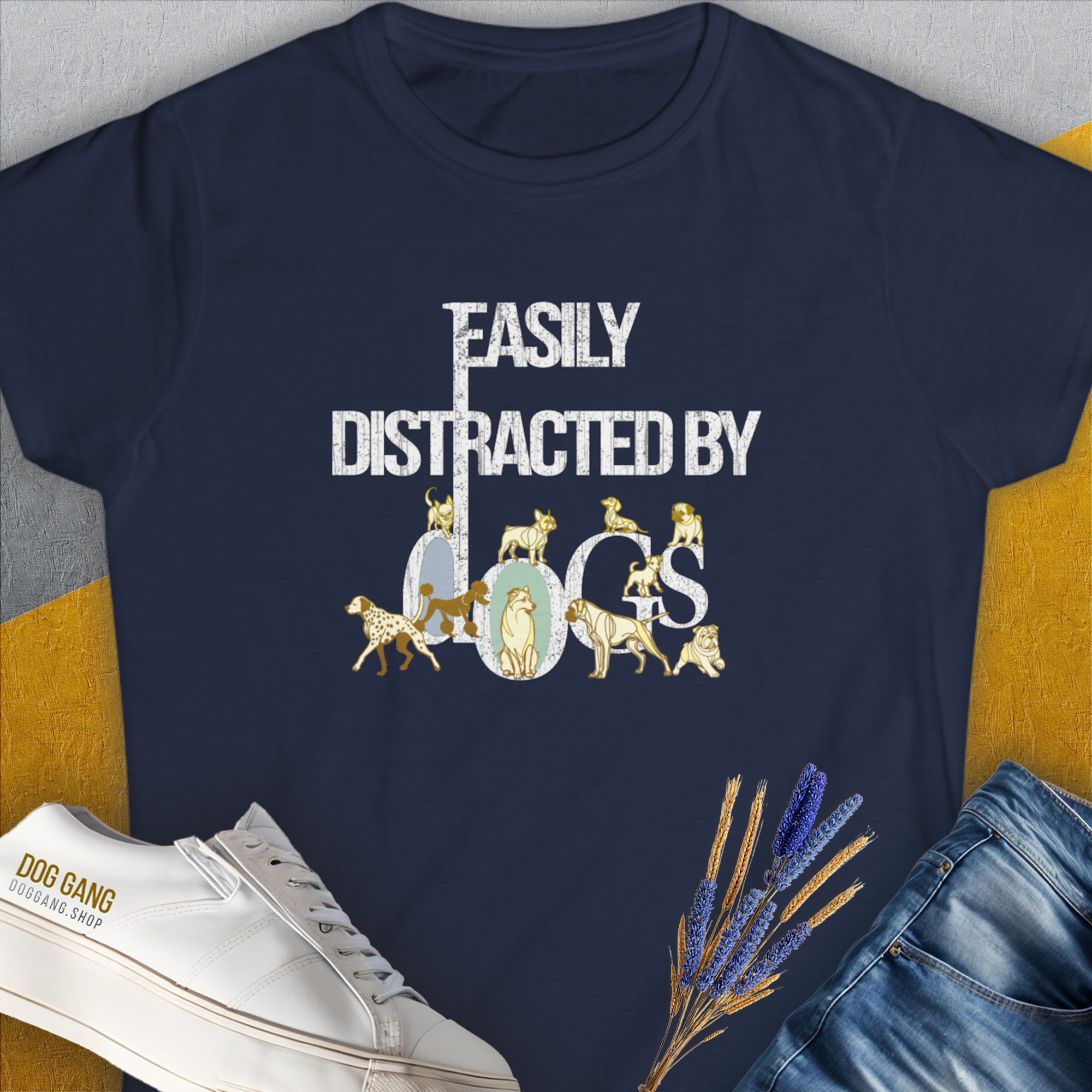 The navy Easily Distracted By Dogs Series, Volume 1 womens t-shirt is made from soft ringspun cotton, perfect for dog lovers. It features the text in white and gold, creatively formed by dog illustrations like a Dalmatian, a Golden Retriever, a Pug, a Poodle, Dachshund, French Bulldog, Chihuahua, Husky and more. Designed by Dog Gang.