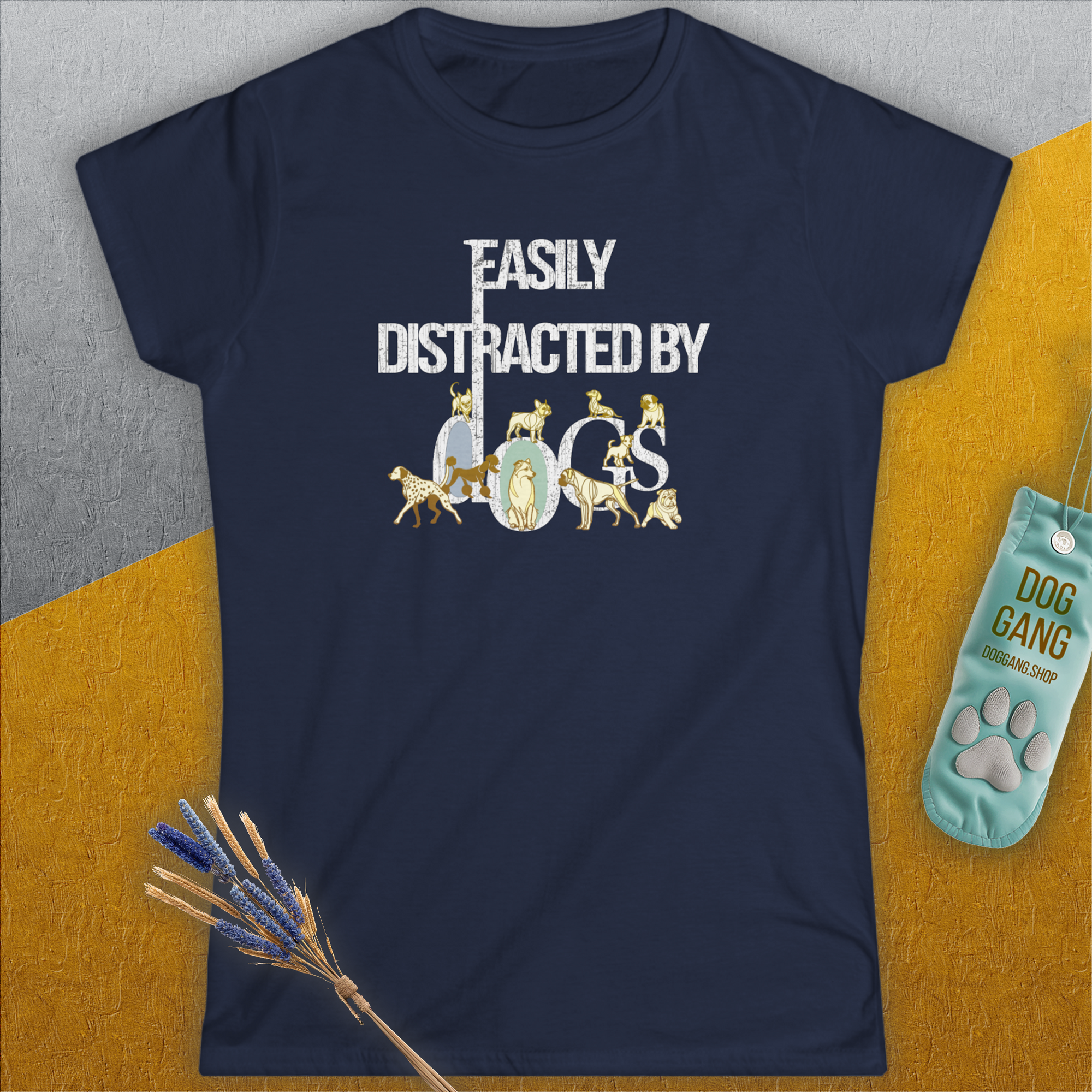 The Easily Distracted By Dogs womens tee, Volume 1, in navy blue showcases a playful dog-themed design with charming dog imagery incorporated within the word Dogs in white. Made from ringspun cotton for a semi-fitted feel. Designed by Dog Gang.