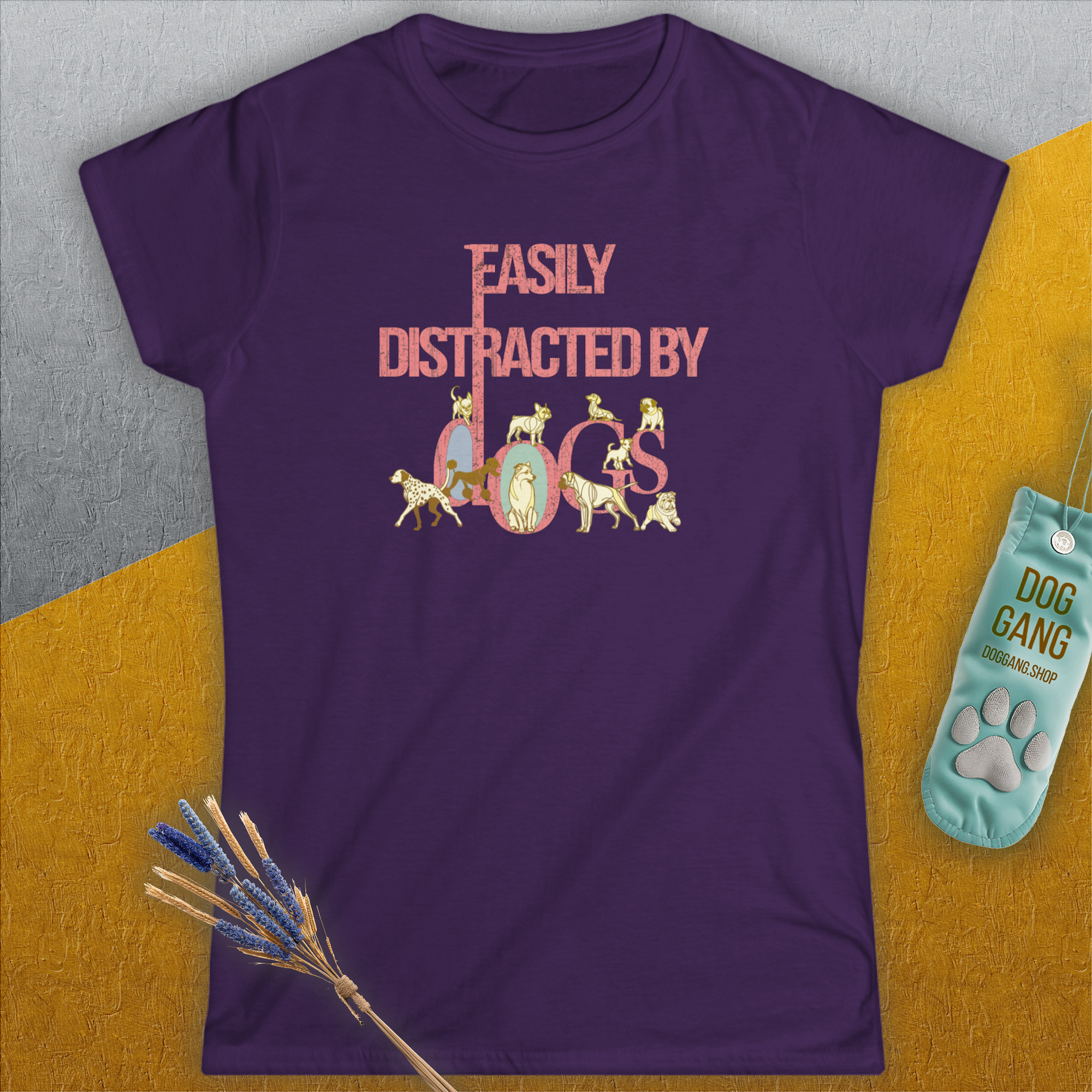The Easily Distracted By Dogs Series, Volume 2, womens t-shirt is a purple semi-fitted design with Easily Distracted by Dogs in pink lettering featuring playful dog illustrations. Designed by Dog Gang.
