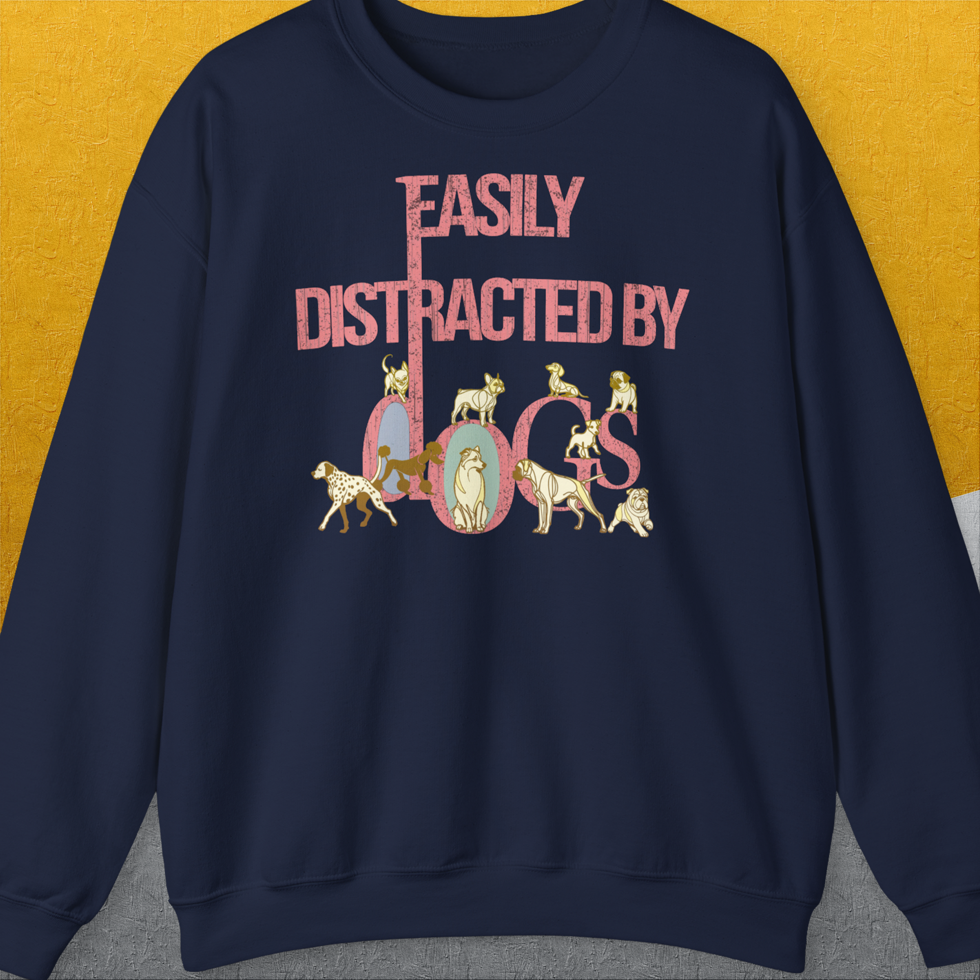 Cute dog design: The unisex navy sweatshirt showcases playful dog illustrations alongside the quote Easily Distracted By Dogs. Designed by Dog Gang.