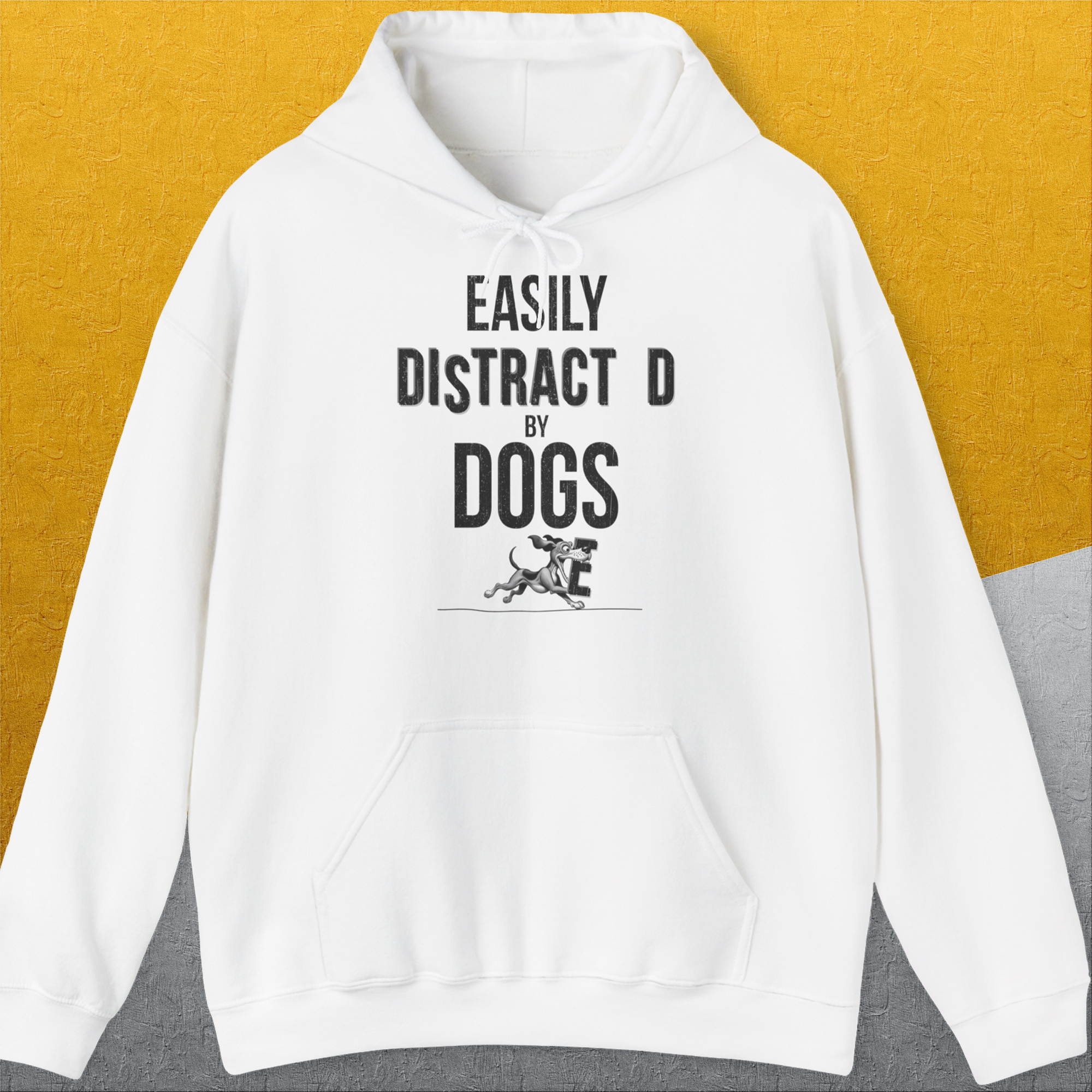 White hoodie with the phrase Easily Distracted By Dogs and a small dog illustration. Perfect for any dog lover. Designed by Dog Gang.