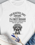 The white t-shirt showcases a funny dog illustration with the witty quote This Beautiful Shirt Contains Finest Dog Hair, Volume 3 from the popular series of the same name. Designed by Dog Gang.