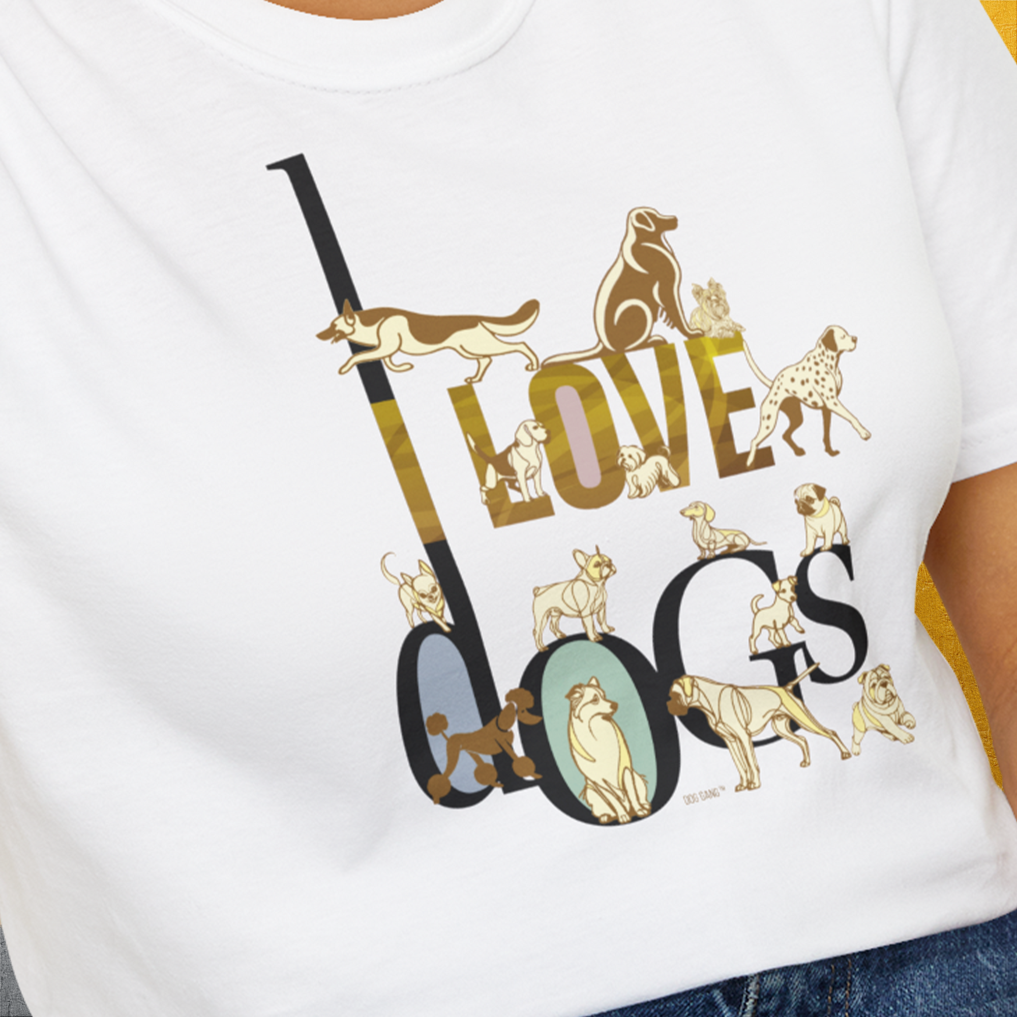 A person wears the I Love Dogs - Series I, Volume 1 unisex T-shirt in white, showcasing a beautiful design of black and gold text creatively intertwined with various dog breed illustrations. Made from 100% cotton for soft comfort. Designed by Dog Gang.