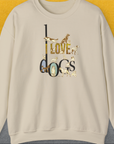 The unisex sweatshirt features I Love Dogs text with illustrated dogs in a cute design. Perfect for any dog lover gift. Designed by Dog Gang.
