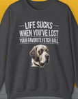 Unisex sweatshirt titled Life Sucks When Youve Lost Your Favorite Fetch Ball, Volume 1 in Dark Heather, featuring a sad dog illustration. A perfect funny shirt for any dog lover. Designed by Dog Gang.